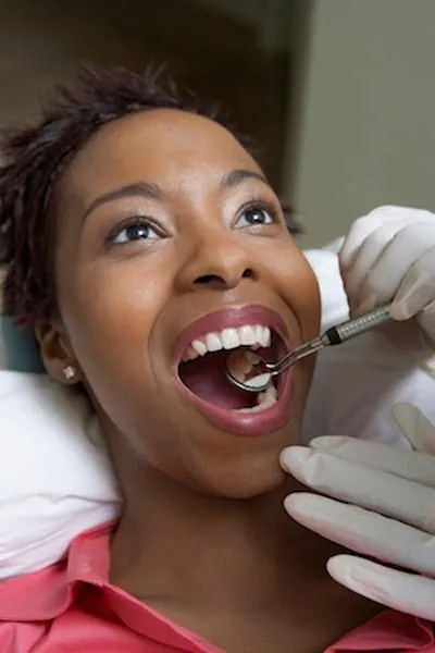 patient getting a dental checkup after getting her new dental veneers