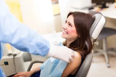 Holt Dental patient showing off her smile after getting dental veneers