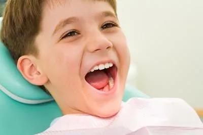 young patient at Holt Dental laughing during his dental appointment